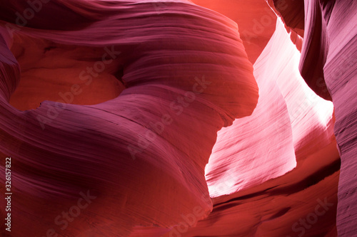 Antelope Canyon, Navajo land east of Page. Perfect natural gradient trendy vibrant colors. Female silhouette. Beautiful canyon of red purple rocks, creation nature. Colorful layout for design.