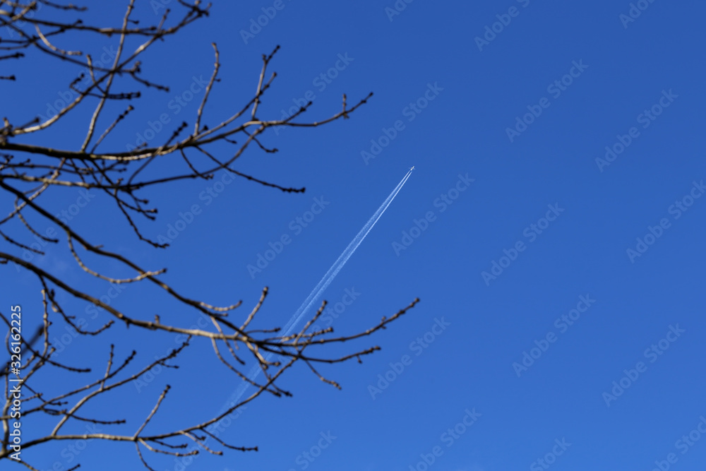 The plane leaves a mark on the blue sky The plane leaves a mark on the blue sky