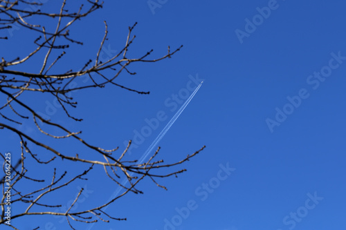 The plane leaves a mark on the blue sky