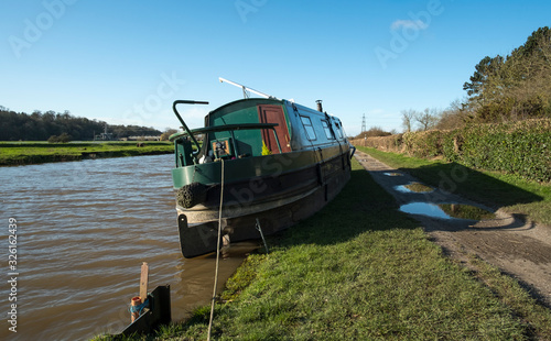 Fototapeta Naklejka Na Ścianę i Meble -  Stern of a stranded canal boat