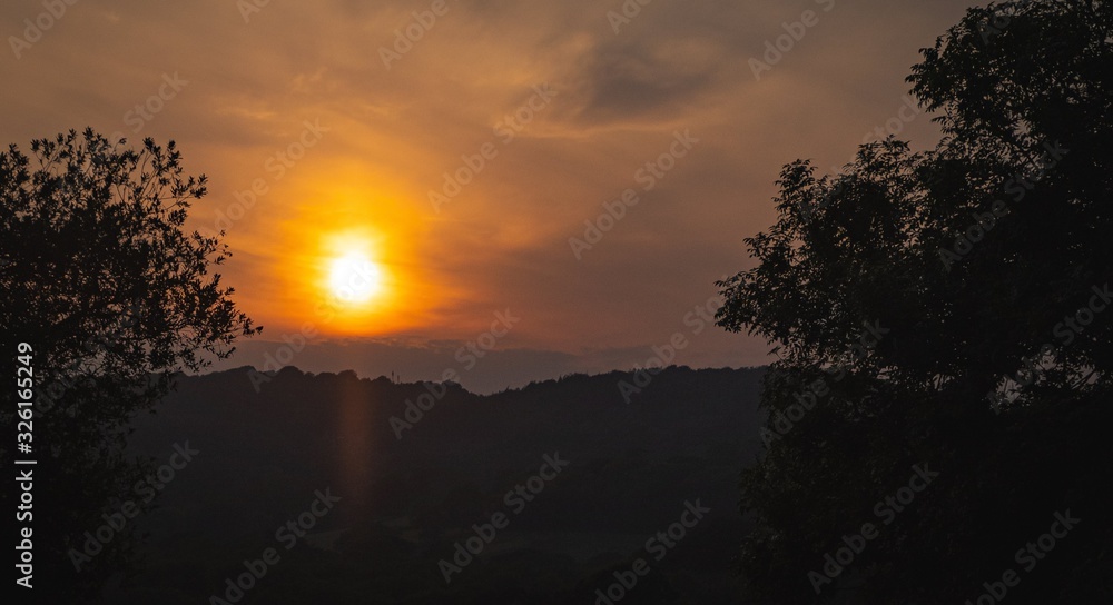 Sunset in the hills with former on a beautiful evening Sunset in the hills with former on a beautiful evening