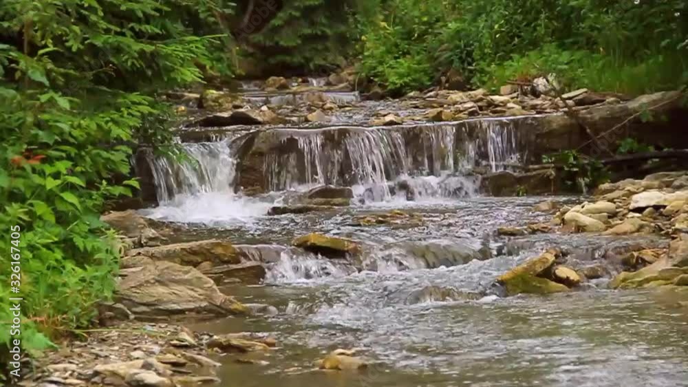 Streaming river in mountains. Calm stream of crystal clear water in river. Ukraine, Carpathians Streaming river in mountains. Calm stream of crystal clear water in river. Ukraine, Carpathians