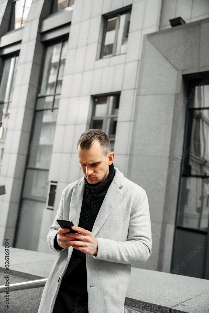 Attractive guy in smart casual with smartphone Attractive guy in smart casual with smartphone