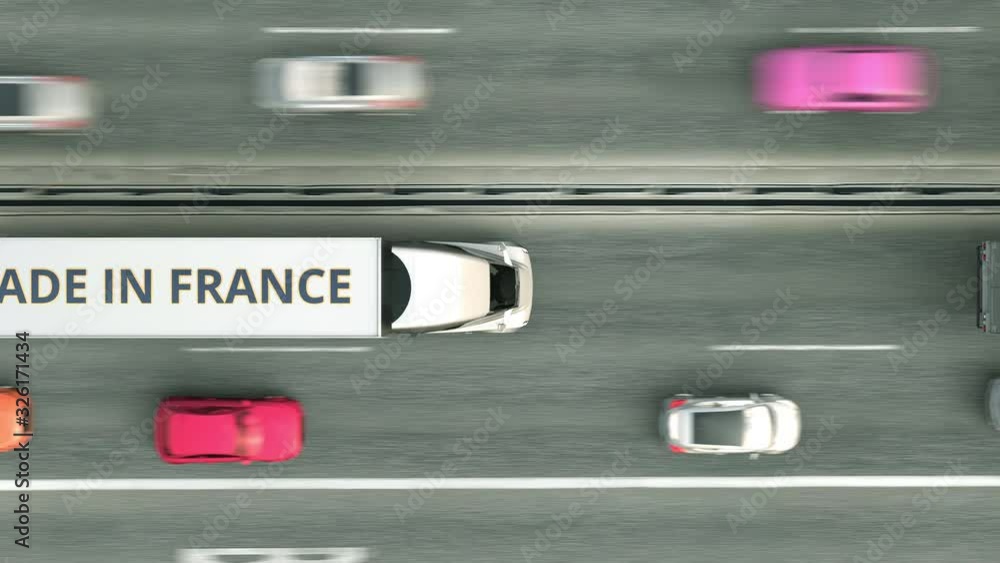 Aerial overhead view of semi-trailer trucks with MADE IN FRANCE text driving along the road. French business related loopable 3D animation Aerial overhead view of semi-trailer trucks with MADE IN FRANCE text driving along the road. French business related loopable 3D animation
