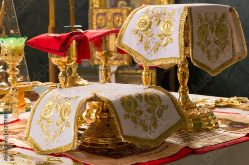 Holy Communion. Golden Chalices with the sanctified Body and Blood of Christ on the Holy See, covered with white covers. Christmas Divine Liturgy in Orthodox Church, Donetsk, Ukraine. 2020, January 7.