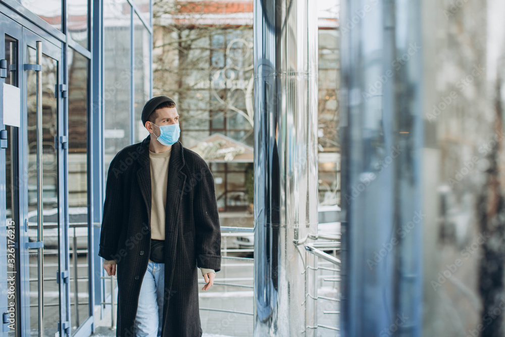 Man in the street wearing protective masks.