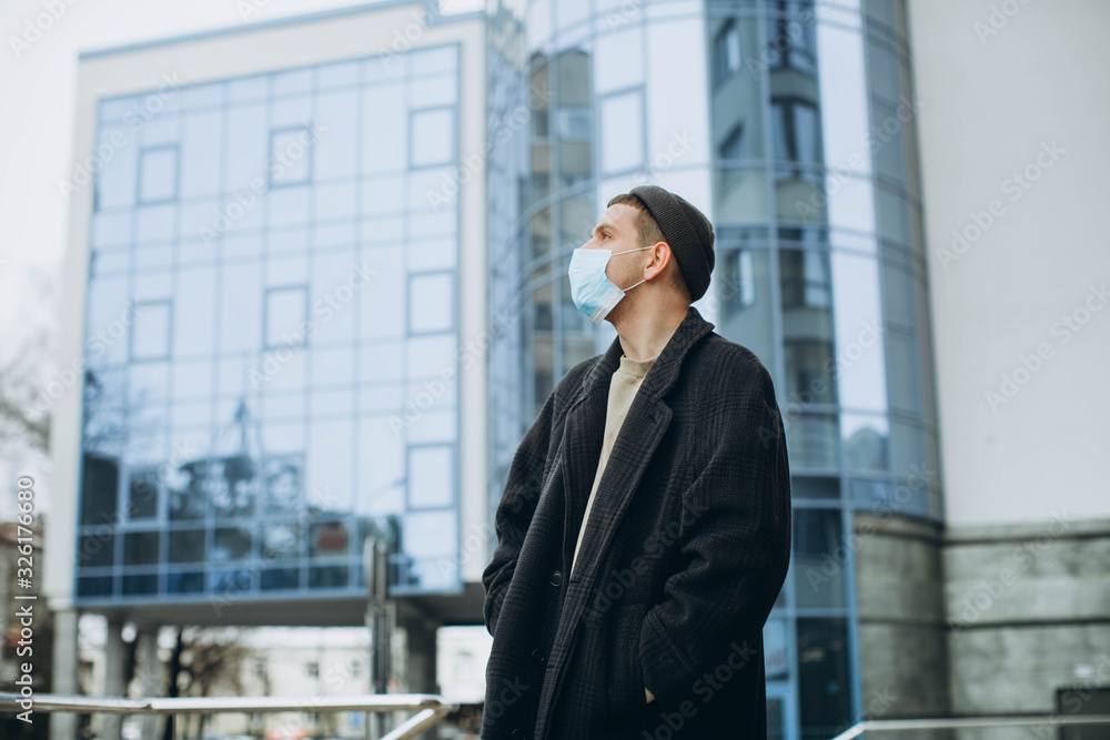 A man wearing a mask on the street. Protection against virus and grip A man wearing a mask on the street. Protection against virus and grip