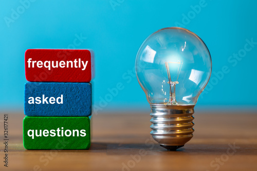 Wallpaper Mural frequently asked questions are the word written on a red and a green toy block. Next to the tow blocks, an ancient light bulb with glowing light stands freely and upright on a dark wooden table. Torontodigital.ca