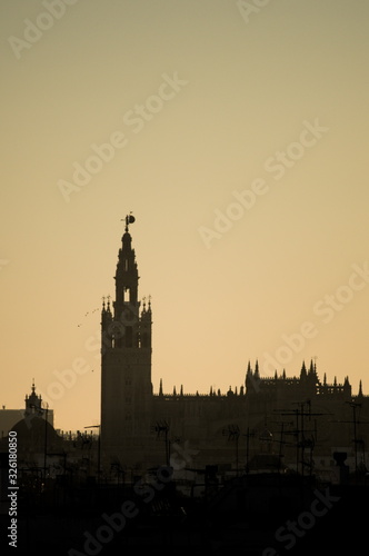 First morning lights over the Giralda tower. Seville, Spain