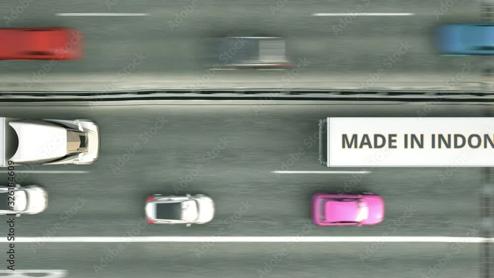 Aerial top down view of semi-trailer trucks with MADE IN INDONESIA text driving along the road. Indonesian business related loopable 3D animation Aerial top down view of semi-trailer trucks with MADE IN INDONESIA text driving along the road. Indonesian business related loopable 3D animation