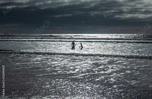 Two kids playing on the beach