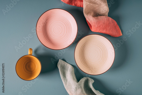 Still life of pastel colored ceramic dishes with ombre linens photo