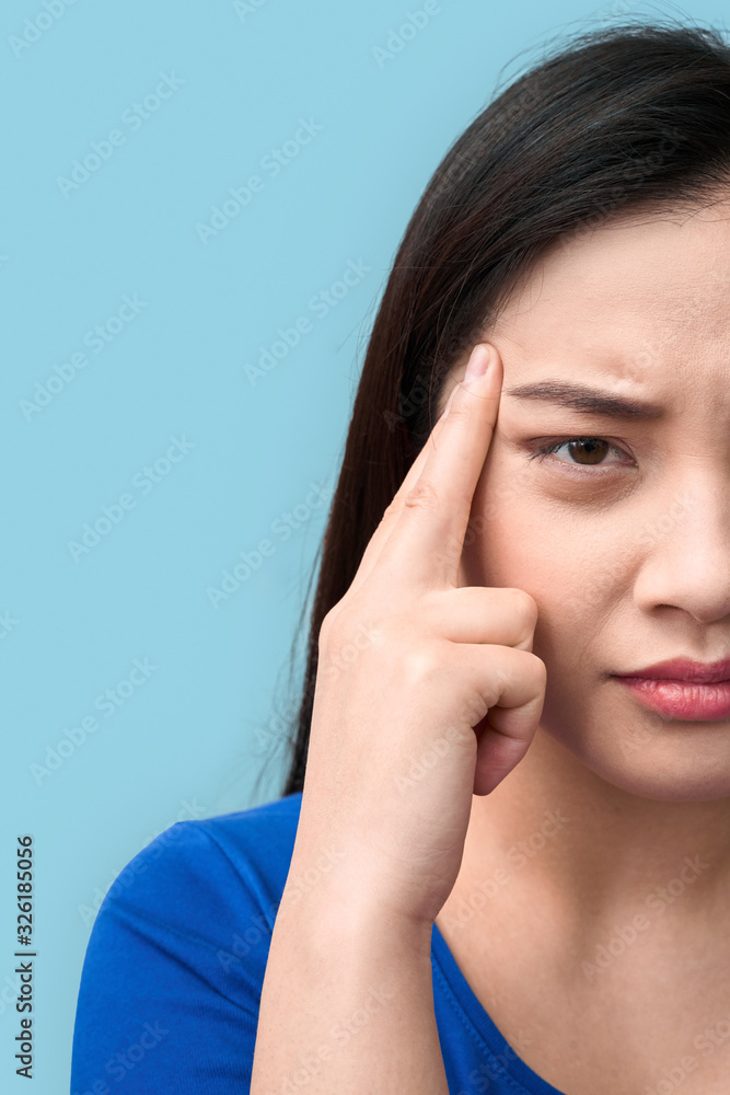 Freestyle. Chinese woman standing isolated on grey having headache wincing unhappy close-up Freestyle. Chinese woman standing isolated on grey having headache wincing unhappy close-up