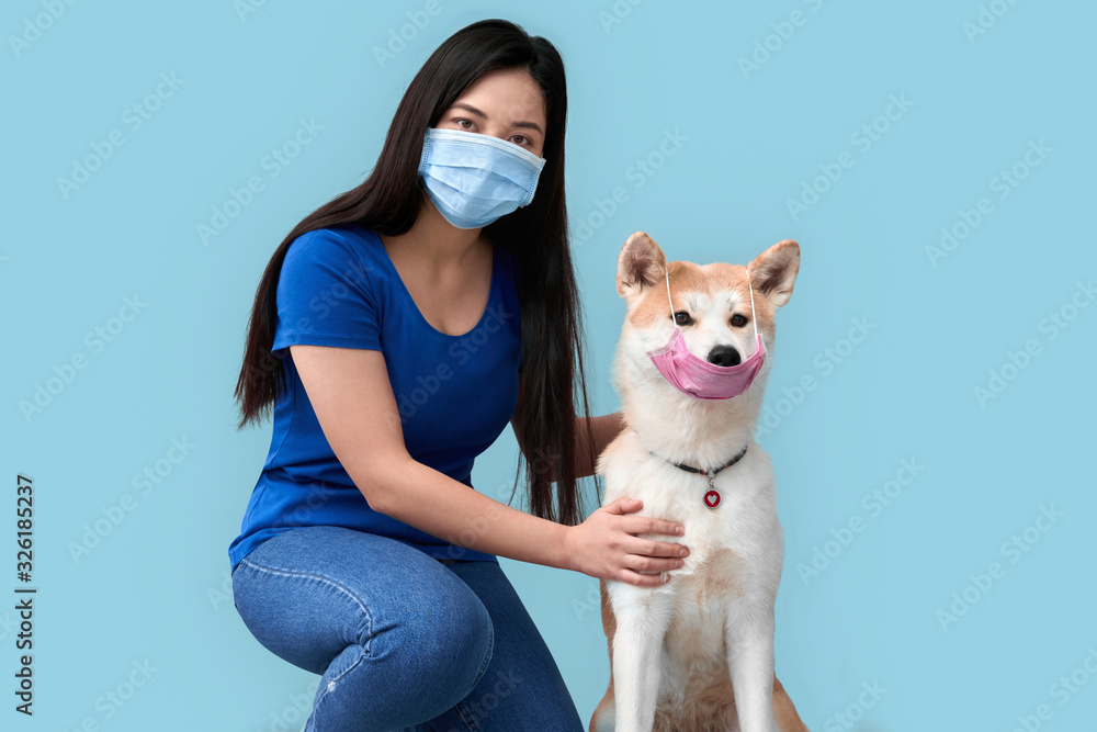 Young adult asian girl and her dog wearing in safety mask Young adult asian girl and her dog wearing in safety mask