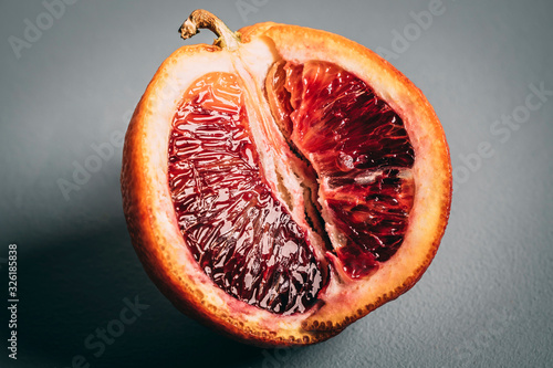 Cut blood orange on grey background