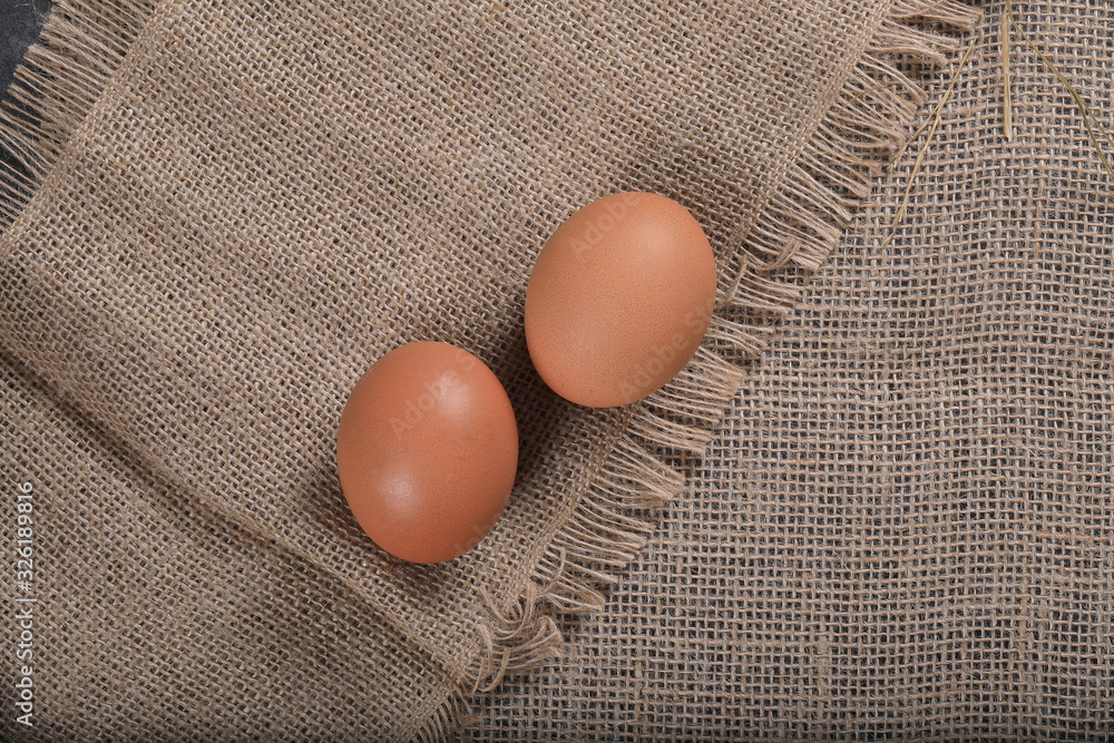 Healthy homemade eggs in hay on linen canvas background. Easter concept. Healthy homemade eggs in hay on linen canvas background. Easter concept.