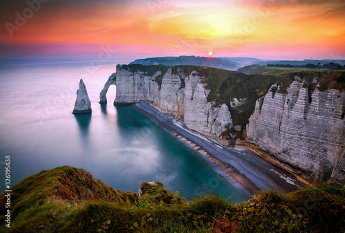 banner of coastal landscape along the Falaise d'Aval the famous white cliffs of Etretat village with the Porte d'Aval natural arch and the rock known as the Aiguille d'Etretat
