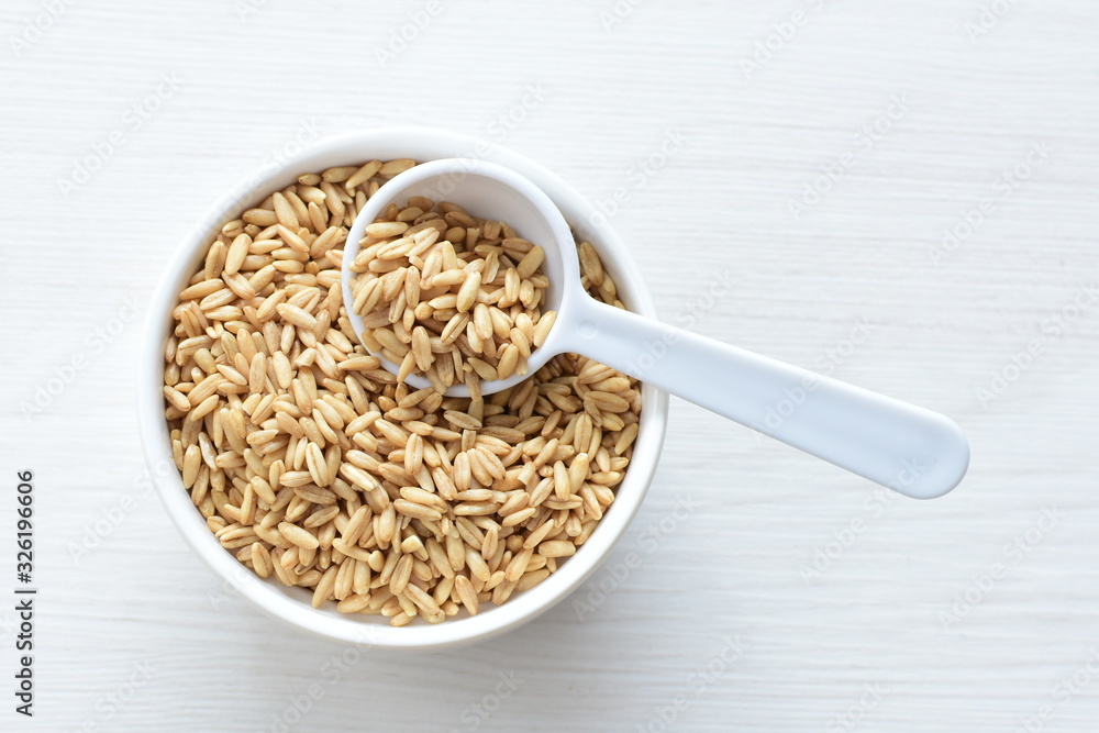 Oat grains accompanied by wheat ears in containers for display Oat grains accompanied by wheat ears in containers for display