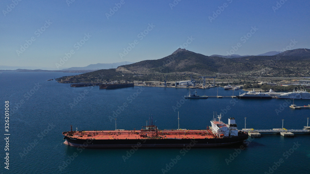 Aerial drone photo of huge fuel tanker ship docked in industrial area of Elefsina, Attica, Greece