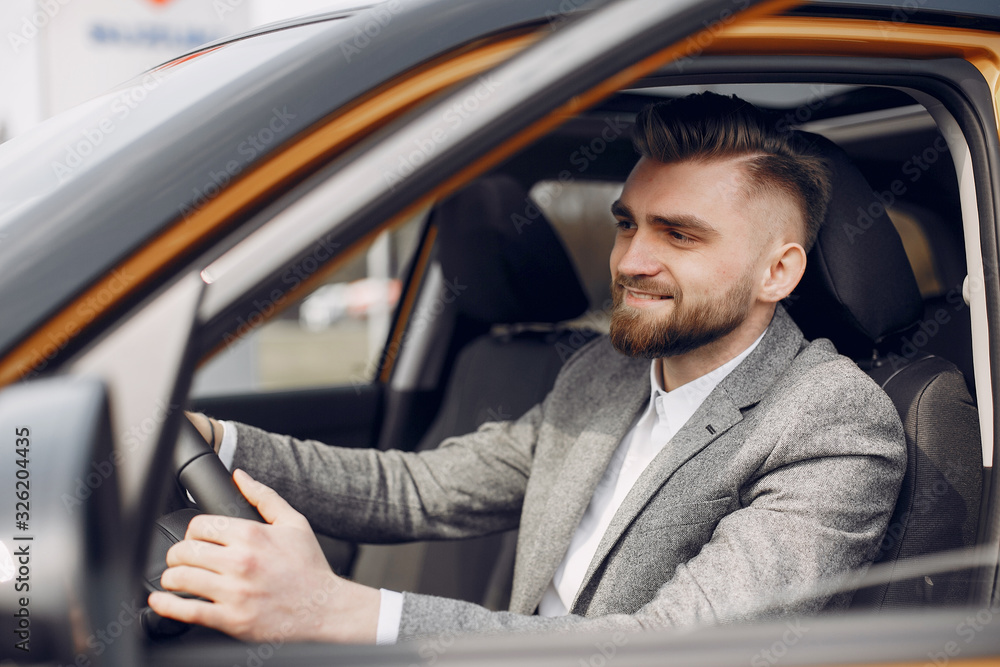 Man buying the car. Businessman in a car salon Man buying the car. Businessman in a car salon