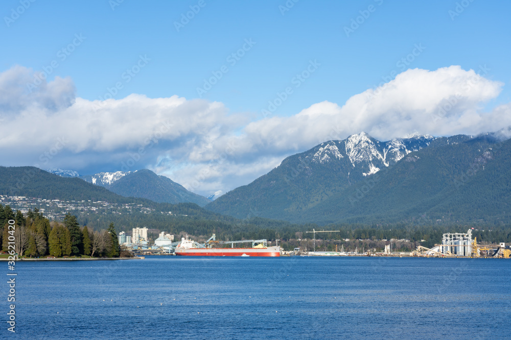 Mountain View with clouds in a Beautiful blue sky day at West Coast seaport in Vancouver, British Columbia, Canada.