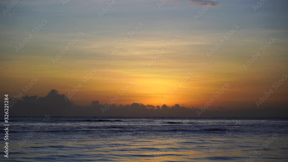 Beautiful sunrise over the Indian Ocean on the island of Zanzibar, Tanzania, east Africa. Travel and nature concept. Sun, blue sky and sea water Beautiful sunrise over the Indian Ocean on the island of Zanzibar, Tanzania, east Africa. Travel and nature concept. Sun, blue sky and sea water