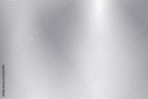Light shining down on silver foil metallic wall with copy space, abstract texture background