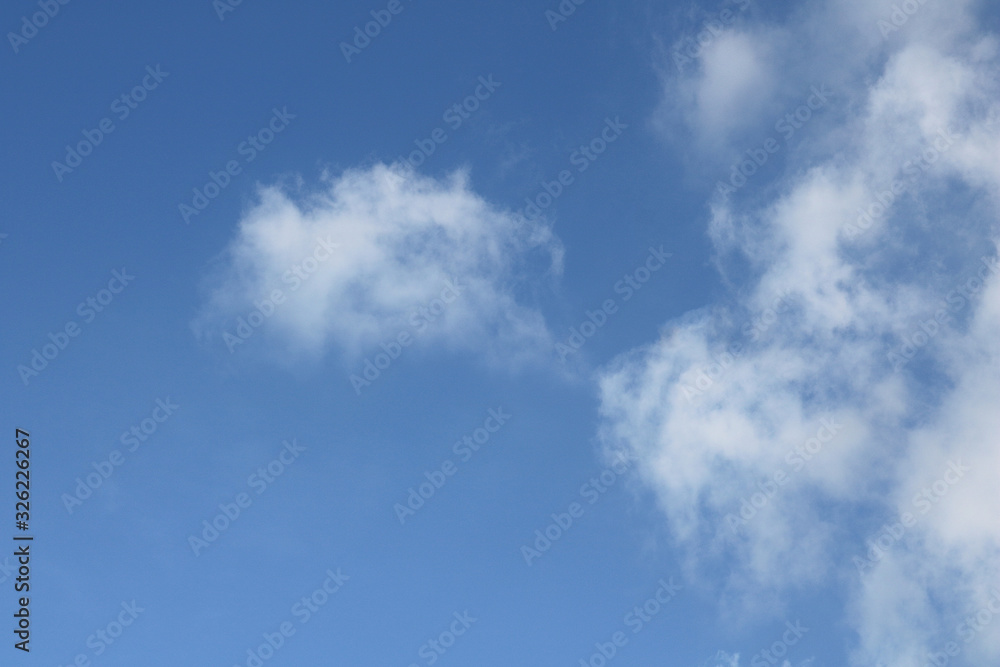Beautiful white clouds against the background of the blue sky Beautiful white clouds against the background of the blue sky