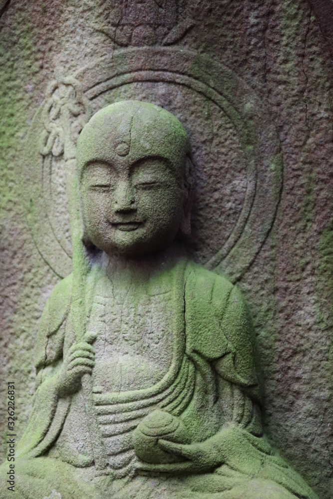 Stone statue of smiling Jizo-bosatsu (Ksitigarbha)
