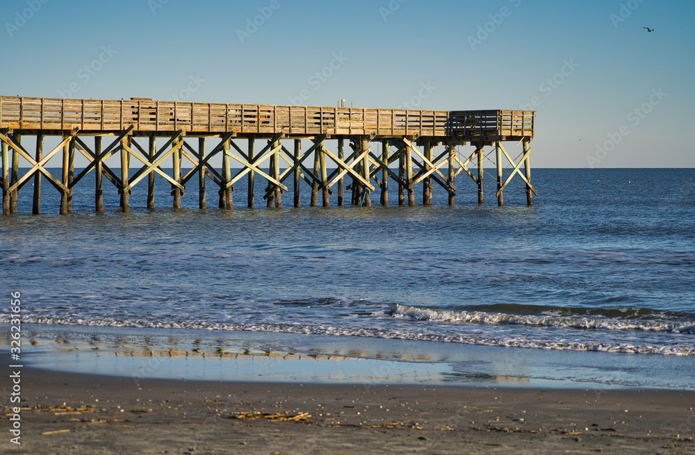 Anglerpier, Pier aus Holz die über das Meer ins Wasser ragt bei wolkenlosem Himmel