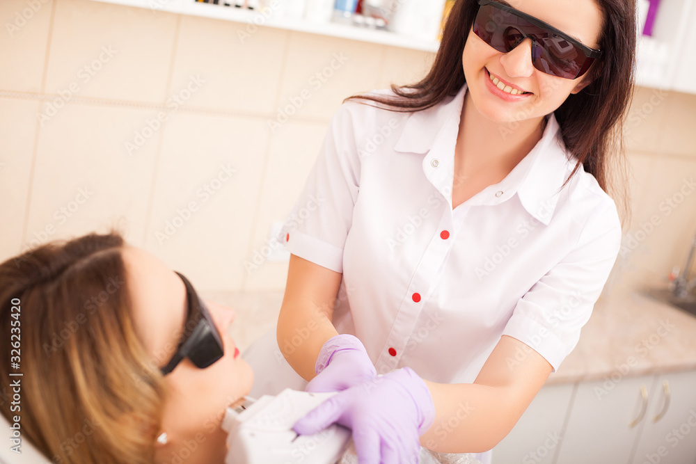 Obraz premium Adult woman having laser hair removal in professional beauty salon