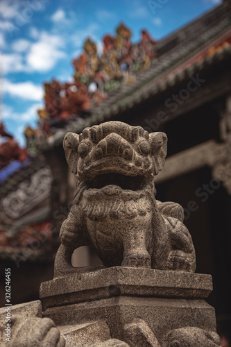 Close up of Fu dog in ancient temple. Chinese culture  art in the roof. Asian architecture. Exotic Tavel and Destination