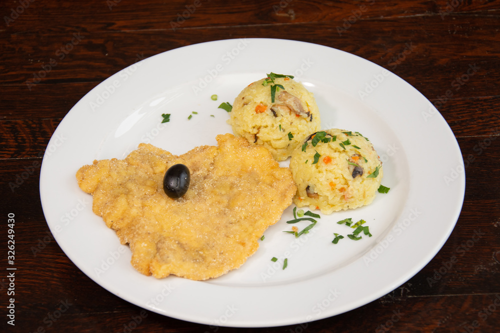Chicken breast schnitzel with rice and olives Chicken breast schnitzel with rice and olives