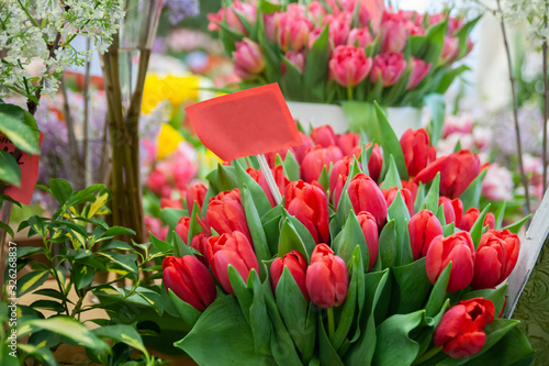 Chic bouquet of red tulips with a sign copyspace, Hello Spring and Woman day concepts