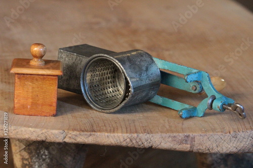 old walnut food grater on wooden table