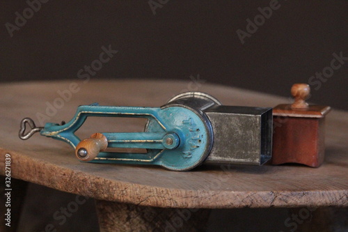 old kitchen grater tool on wooden board