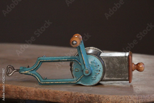 old tool food grater on a wooden board