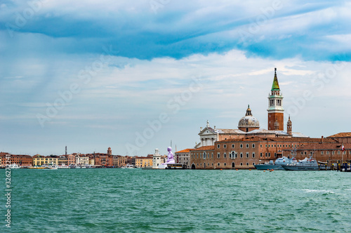 Venice, Italy - CIRCA 2013: Venice buildings and Basilica San Marco tower as seen from Venice lagoon.
