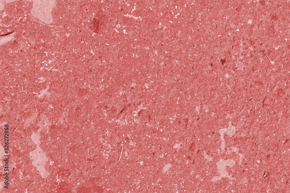 Fototapeta premium Old asphalt surface close up. Abstract background red color toned