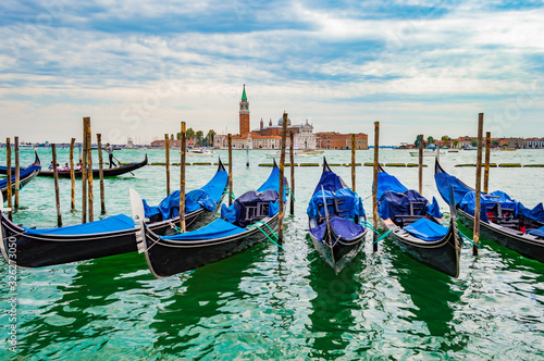 Venice, Italy - CIRCA 2013: Venice gondolas at a cloudy afternoon. San Giorgio Maggiore Church is visible on the background. © HaniSantosa