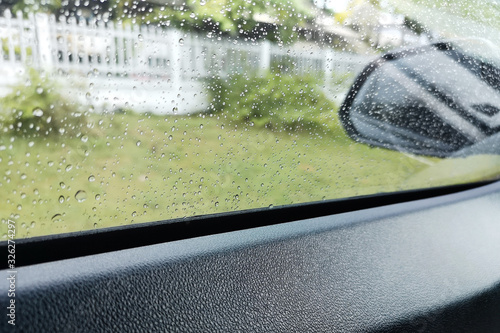 View through the sideview mirror ,roadside area On a rainy day, the weather is bad.