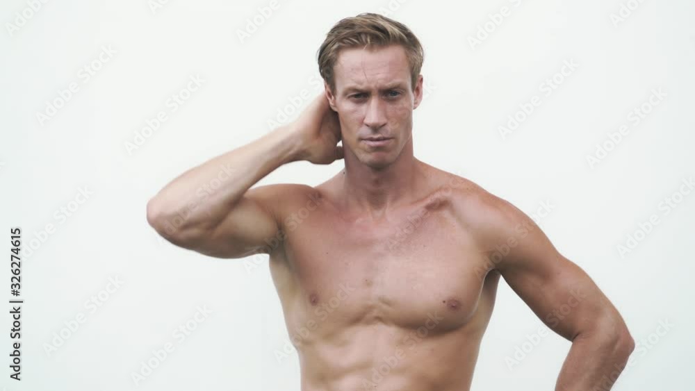 blond guy with bare torso plays different emotions in studio blond guy with bare torso plays different emotions in studio