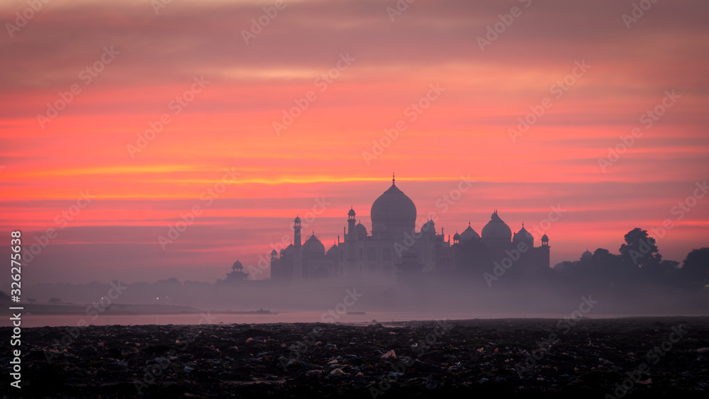 sunrise with mystic foggy sky of taj mahal