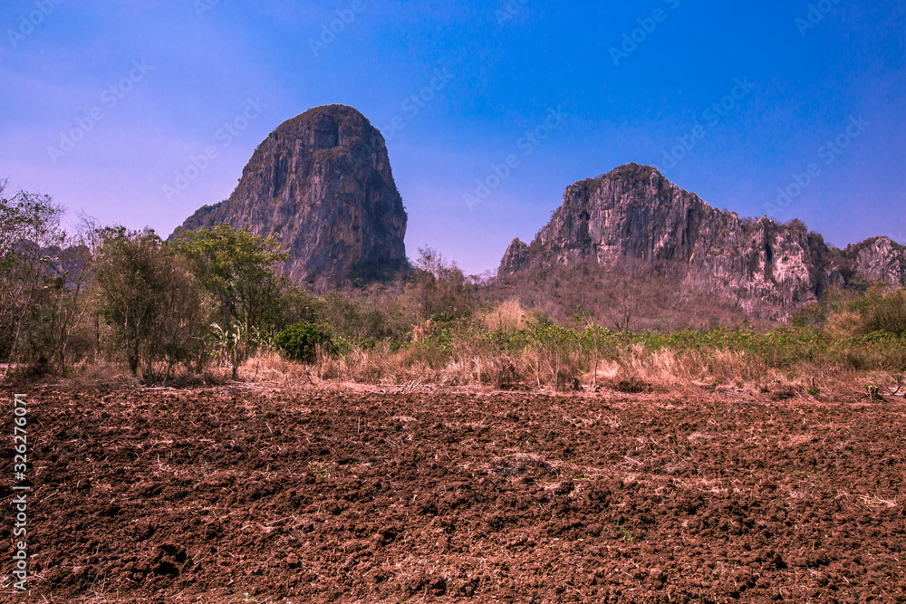 Wallpaper blurred nature of the atmosphere of high mountains surrounded by grassland, with a bright blue sky, good weather during the day Wallpaper blurred nature of the atmosphere of high mountains surrounded by grassland, with a bright blue sky, good weather during the day