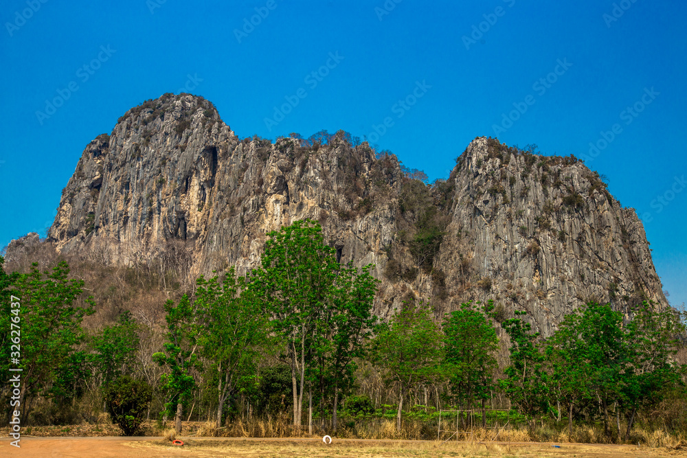 Wallpaper blurred nature of the atmosphere of high mountains surrounded by grassland, with a bright blue sky, good weather during the day Wallpaper blurred nature of the atmosphere of high mountains surrounded by grassland, with a bright blue sky, good weather during the day