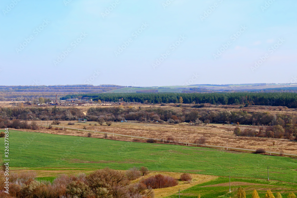 Fototapeta premium Autumn landscape with fields and trees.