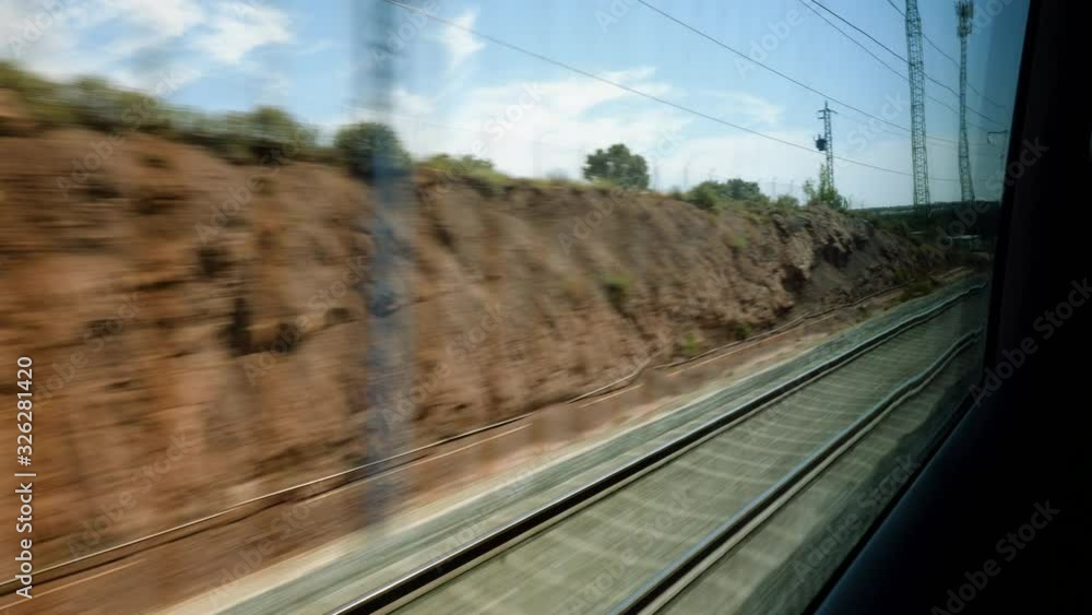 Railroad track. Scenic landscape view from the high speed train driving through suburb of Spain. 4K
