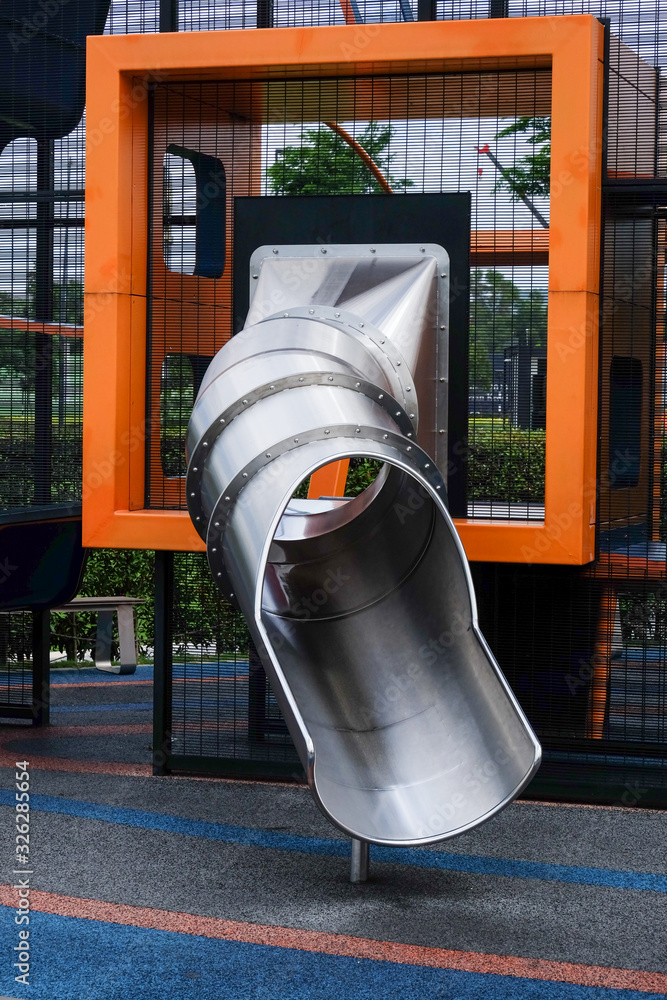 A picture of playground slide made of metal.