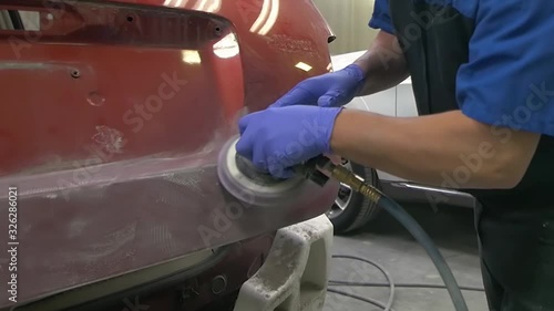 Mechanic Sanding Car for Body work at shop Auto Repair Collision