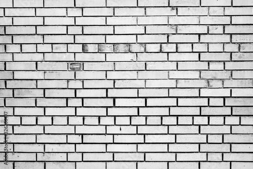 Texture of a brick wall with cracks and scratches which can be used as a background